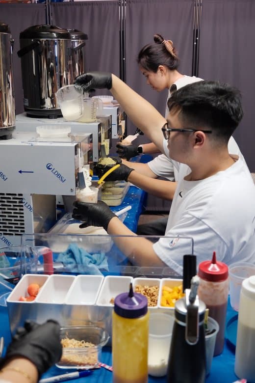 Making shaved ice behind the pop-up counter