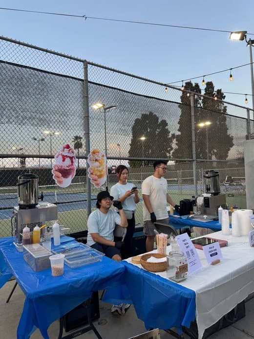 The Snow° pop-up by the courts at dusk
