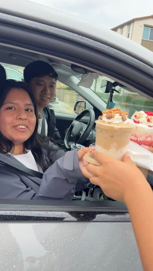 Handing a Snow° cup through a car window